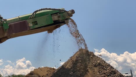 Crushed-rocks-and-concrete-coming-off-the-belt-of-a-rock-crusher
