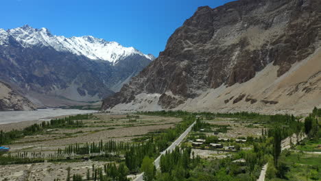 Cinematic-drone-shot-of-Passu-Cones-in-Hunza-Pakistan,-moving-towards-the-Tupopdan-Peak,-wide-aerial-shot