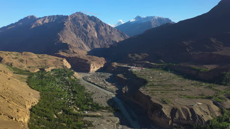 Cinematic-aerial-shot-of-Passu-Cones-in-Hunza-Pakistan,-the-Tupopdan-Peak-in-the-distance,-wide-drone-shot