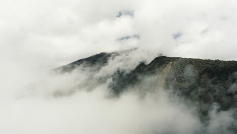 Clouds-And-Mist-Covering-Tungurahua-Volcano-In-Baños,-Ecuador---aerial-drone-shot