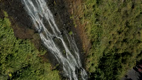 Drone-Ascends-Through-Cascada-de-la-Virgen-In-Banos-City,-Ecuador