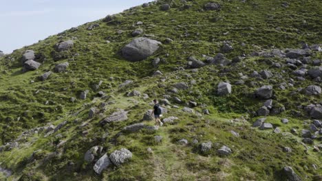 Drone-hovers-over-a-hiker-on-the-mountain's-hiking-trail