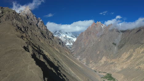 Cinematic-drone-shot-of-Passu-Cones-in-Hunza-Pakistan,-Tupopdan-Peak,-snow-covered-mountain-peaks-with-steep-cliffs,-wide-aerial-shot