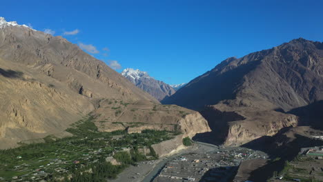 Cinematic-drone-shot-of-Passu-Cones-in-Hunza-Pakistan,-with-Tupopdan-Peak-in-the-distance,-panning-wide-aerial-shot