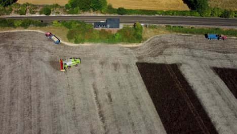Aerial-footage-of-agricultural-vehicles-during-a-harvest