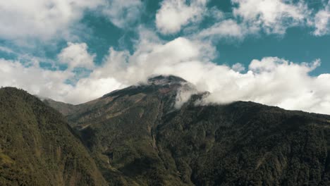 Tungurahua-Volcano-Against-Blue-Cloudy-Sky-In-Baños-de-Agua-Santa,-Ecuador---tilt-up