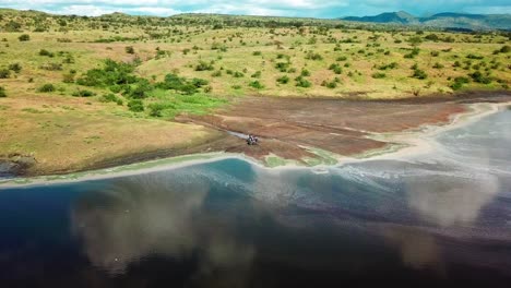 Motorcyclists-Parked-Beside-The-Beautiful-And-Shallow-Lake-Magadi-In-Kenya,-Africa