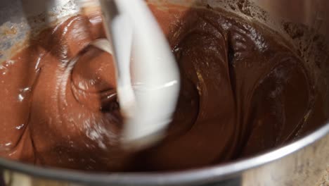 Close-up-shot-of-cake-batter-being-blended-with-a-paddle-attachment-on-a-stand-mixer