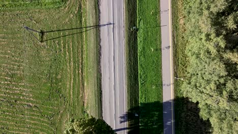 Arial-Drone-shot-over-the-road-and-the-bike-road-next-to-it