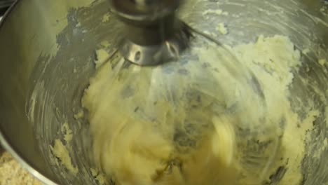 Handheld-shot-of-butter-being-whipped-in-a-stand-mixer