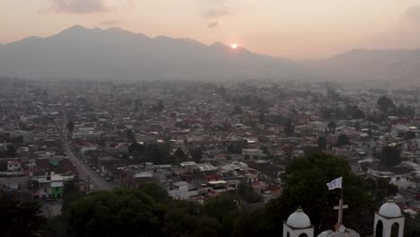 Aerial-passing-by-Guadalupe-Church-during-sunset,-San-Cristobal-de-las-Casas,-Chiapas,-Mexico