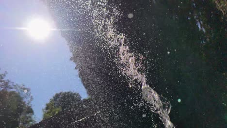 Slow-Motion-Hose-Water-and-Sun-Flare-in-Garden-on-Hot-Sunny-Day-Wales-UK