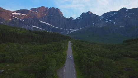Dreaming-about-driving-with-the-van-on-Lofoten-Island-during-summer-holiday,-Aerial-Ascending-drone-Shot