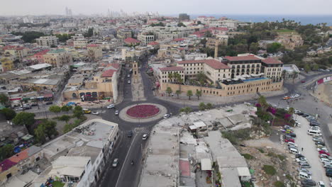 Aerial-view-at-sunrise-over-the-city-of-Jaffa-in-Israel,-passing-over-the-main-square-of-Jaffa-and-the-ancient-clock-tower-of-the-city-1