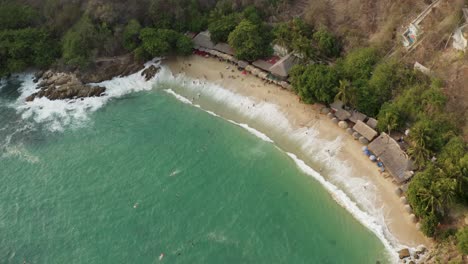 Aerial-flies-over-Playa-Carrizalillo-during-daytime-in-Puerto-Escondido,-Mexico