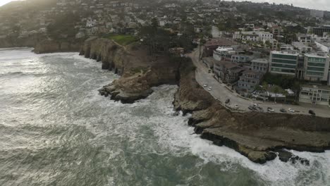 Coastline-Cliffs-with-Ocean-Waves-in-San-Diego,-California-at-Sunset---Aerial