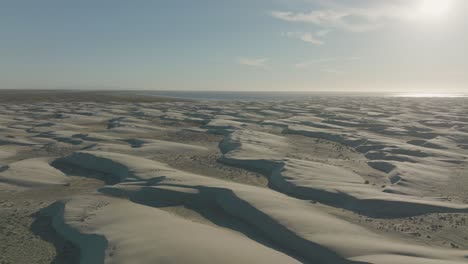 Beautiful-Sand-Dune-Scenery-of-Baja-California-Sur-Shoreline,-Aerial-Flight-with-Copy-Space-in-Sky
