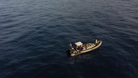 A-small-single-boat-is-floating-outside-the-coast-of-Madeira