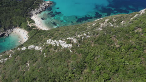 Aerial-shot-of-a-double-beach-and-the-trekking-path-that-leads-to-the-hidden-beach