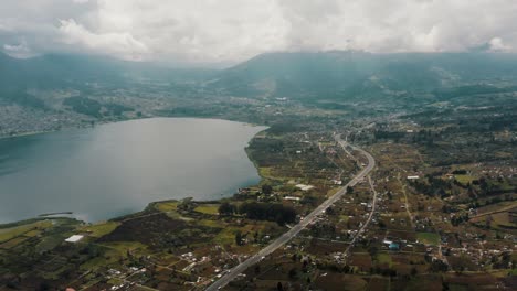 Landscape-Of-Otavalo-With-San-Pablo-Lake-And-Imbabura-Stratovolcano-In-Ecuador---aerial-panoramic