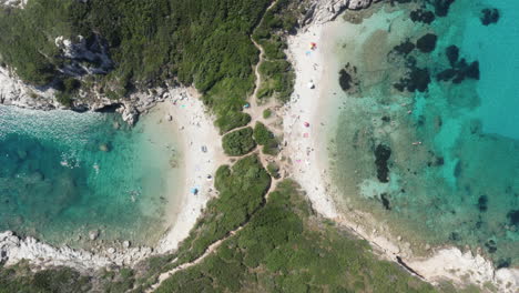 Aerial-top-down-shot-ascending-to-reveal-a-unique-double-beach-and-it's-beautiful-small-coves