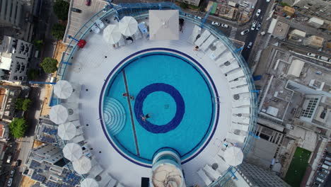 Aerial-shot-of-a-beautiful-pool-on-a-tall-tower-in-Tel-Aviv-and-the-beaches-of-Tel-Aviv