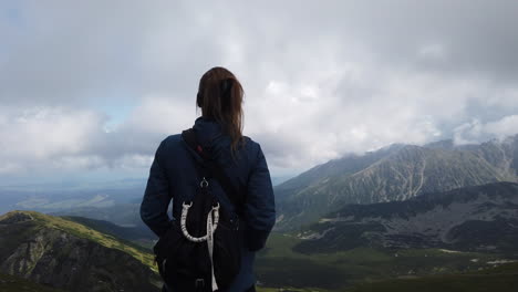 Cinematic-shot-of-girl-enjoying-the-scenery-of-the-Tatra-mountains-including-its-wonderful-lakes-1