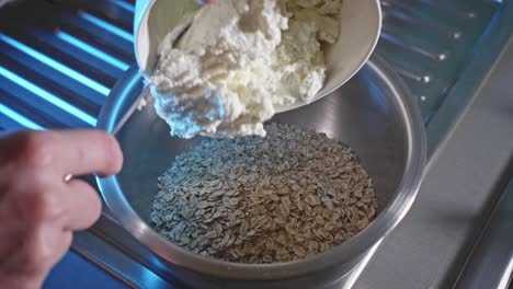 Pouring-Oatmeal-Into-A-Mixing-Bowl,-Adding-Low-fat-Cheese-And-Eggs
