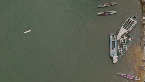 Slow-aerial-flyover-of-fishing-boats-in-Freetown,-Sierra-Leone