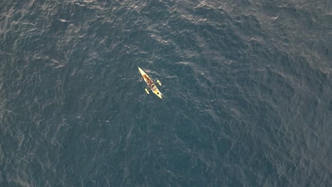 An-angler-in-a-yellow-fishing-kayak-at-the-middle-of-Pacific-Ocean