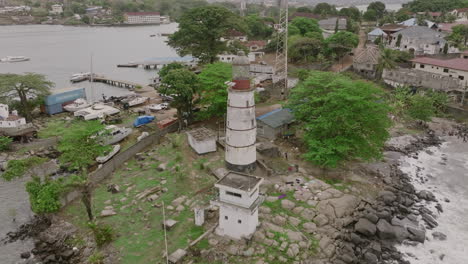 Slow-motion-aerial-pull-out-from-Aberdeen-lighthouse-in-Freetown,-Sierra-Leone