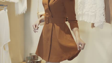Women's-fashion,-girl-is-testing-and-showcasing-brown-colored-dress