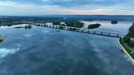 Cinematic-aerial-of-long-bridge-over-river-in-USA
