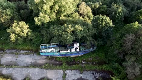 Arial-shot-of-abandoned-ship-near-the-natural-forest-area
