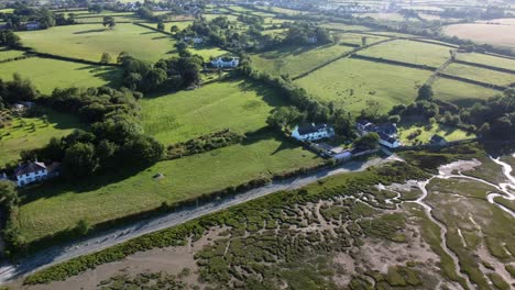 Aerial-view-Traeth-Coch-Pentraeth-farmland-meadows-countryside-with-vacation-cottages-along-salt-marsh