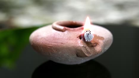 A-clay-oil-lamp-from-the-Middle-East-wick-burning-as-it-turns