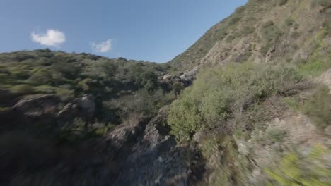 FPV-drone-footage-flying-through-the-mountains-with-views-of-rivers-and-waterfalls