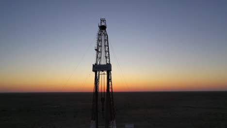 Natural-gas-and-oil-rig-well-working-during-sunset-exploring-gas