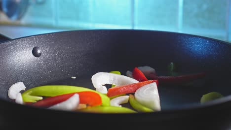 Stir-frying-Green-And-Red-Bell-Peppers-With-White-Onion-In-Pan