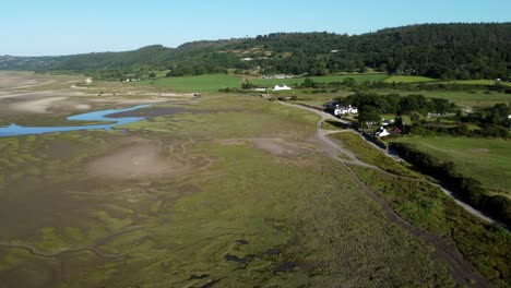 Aerial-view-Traeth-Coch-scenic-salt-marsh-moorland-countryside-at-sunset-panning-left
