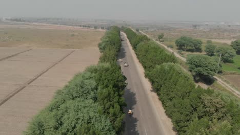 Aerial-Dolly-Along-Road-Going-Through-Rural-Farmlands-In-khairpur