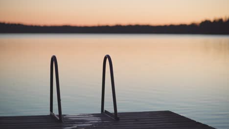 Dock-ladder-on-a-wooden-pier-right-after-the-sunset