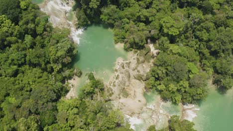 Aerial-is-flying-over-Roberto-Barrios-Pools,-Birdview-during-daytime,-Palenque,-Chiapas,-Mexico