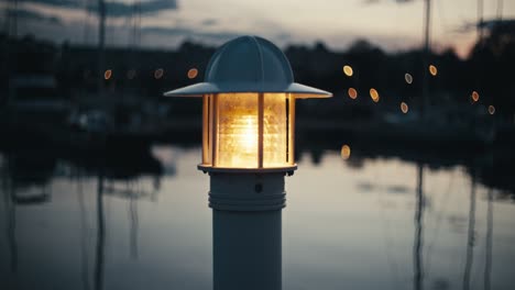 Marina-Lamp-at-Night-with-Subtle-Water-Background-Light-Bokeh-Dusk-Reflections-4K