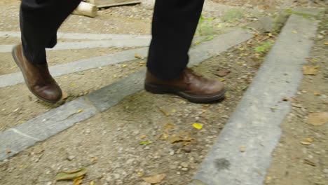 Closeup-Of-Large-Man-Shoes-Walking-Along-A-Path-In-The-Woods