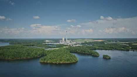 Wide-aerial-hyperlapse-with-power-plant-centered-in-frame-and-boats-on-the-water-in-the-foreground-at-Hyco-Lake,-North-Carolina