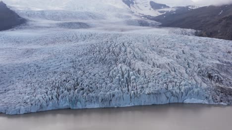 Fjallsárlón-frozen-glacier-in-Iceland,-impressive-grand-ice-mass,-aerial