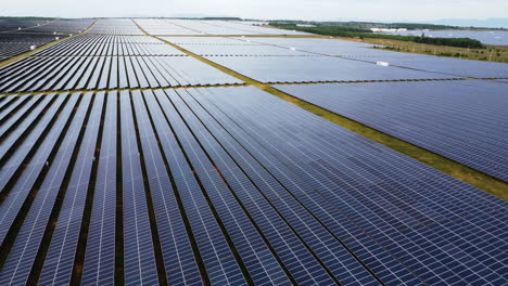 Aerial-pan-right-over-field-with-newly-built-solar-panels,-Binh-thuan,-Vietnam