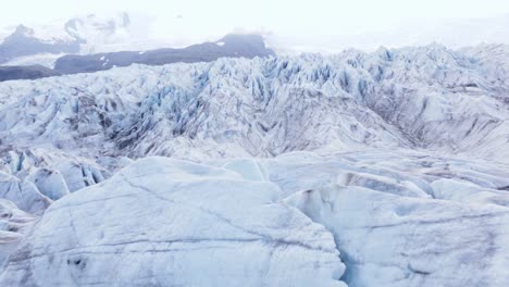 Jagged-ice-on-surface-of-big-large-glacier-in-Iceland,-Fjallsárlón,-aerial