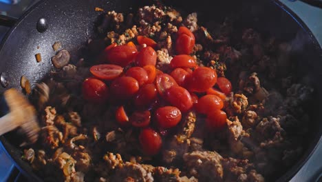 Adding-Fresh-Cherry-Tomatoes-To-Ground-Turkey-Meat-Cooking-In-Pan